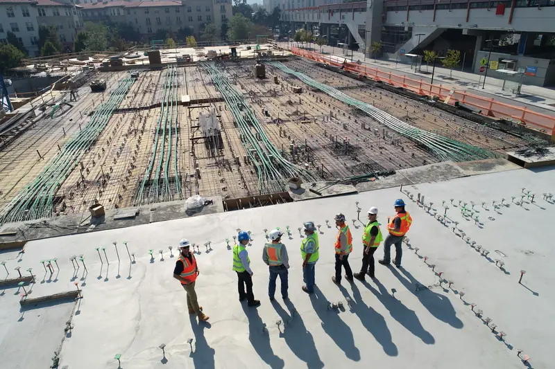 A team of engineers on a concrete slab, seen from above